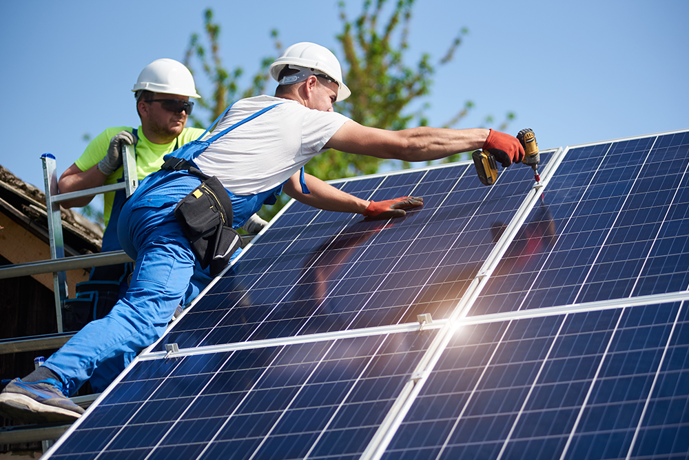 solar panels being attached to roof